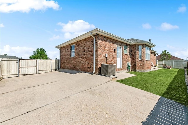 3945 Jean Lafitte Pkwy, Chalmette, LA 70043 - rear view of property with a gate, brick siding, a patio area, and central air condition unit