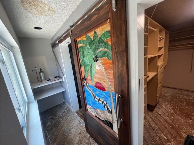 200 Macque St, Harahan, LA 70123 - corridor with hardwood / wood-style floors and a textured ceiling