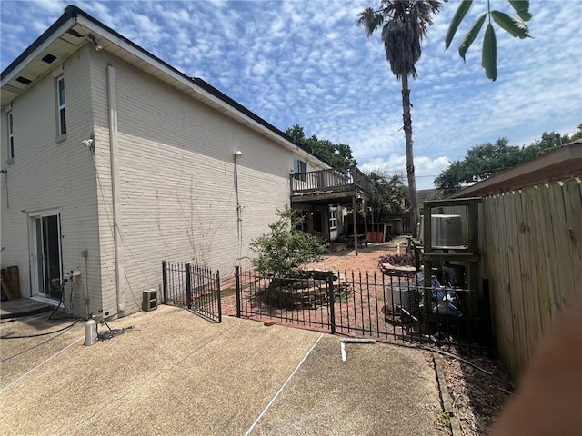 200 Macque St, Harahan, LA 70123 - view of side of home with a patio, fence, and brick siding