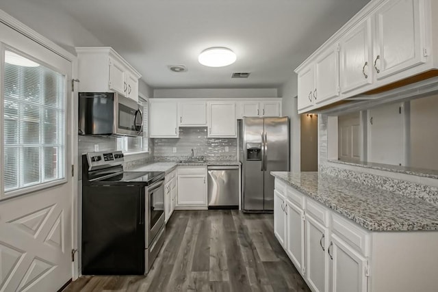 8209 Harris Ave, Harahan, LA 70123 - kitchen with appliances with stainless steel finishes, a sink, and white cabinets