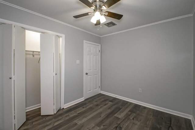 8209 Harris Ave, Harahan, LA 70123 - unfurnished bedroom with dark wood-style floors, crown molding, baseboards, ceiling fan, and a closet