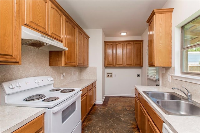 309 2nd Ave, Hammond, LA 70403 - kitchen with white electric range oven, under cabinet range hood, a sink, and tasteful backsplash