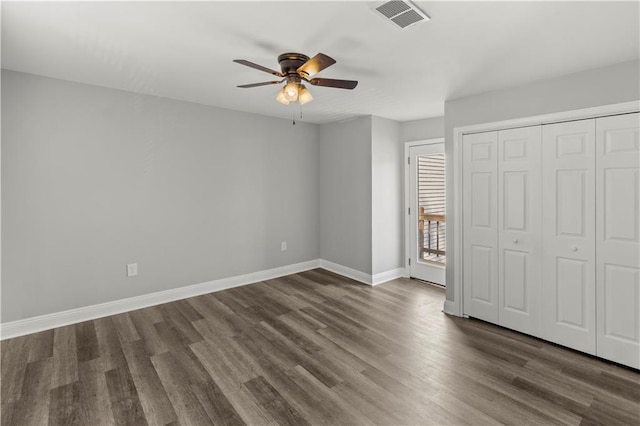 112 Napoleon Ave Unit 30, Slidell, LA 70460 - unfurnished bedroom featuring dark wood-style flooring, a ceiling fan, and a closet