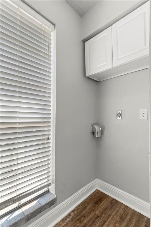 112 Napoleon Ave Unit 30, Slidell, LA 70460 - laundry room with dark wood finished floors, baseboards, cabinet space, and electric dryer hookup