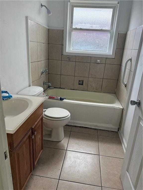 bathroom featuring plenty of natural light, tile patterned floors, vanity, and toilet