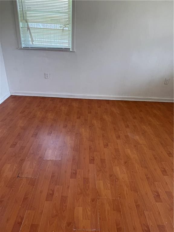unfurnished room with light wood-style floors and baseboards