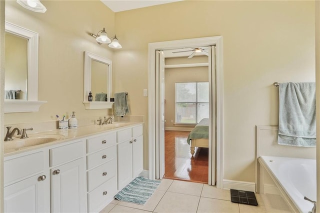 119 Kasey St, Slidell, LA 70458 - ensuite bathroom with tile patterned floors, double vanity, baseboards, and a bathtub