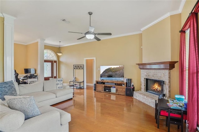 119 Kasey St, Slidell, LA 70458 - living area featuring ornate columns, ceiling fan, wood finished floors, crown molding, and a fireplace