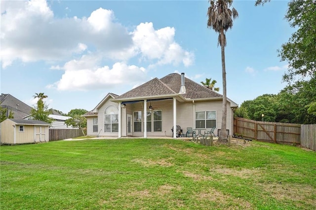 119 Kasey St, Slidell, LA 70458 - rear view of house with ceiling fan, a patio, a shed, an outdoor structure, and a shingled roof