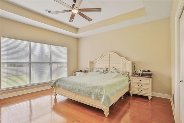 119 Kasey St, Slidell, LA 70458 - bedroom featuring baseboards, a tray ceiling, wood finished floors, and ceiling fan