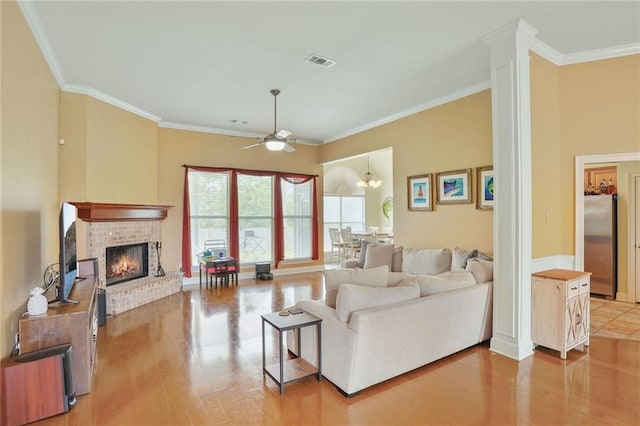 119 Kasey St, Slidell, LA 70458 - living room featuring light wood finished floors, a fireplace, ceiling fan, crown molding, and baseboards