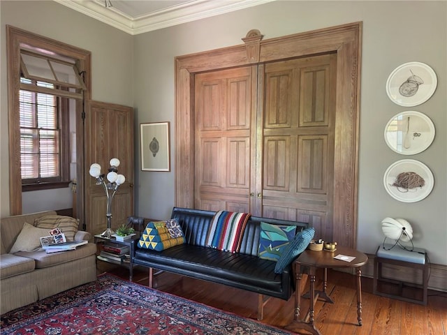 living area featuring wood finished floors and ornamental molding