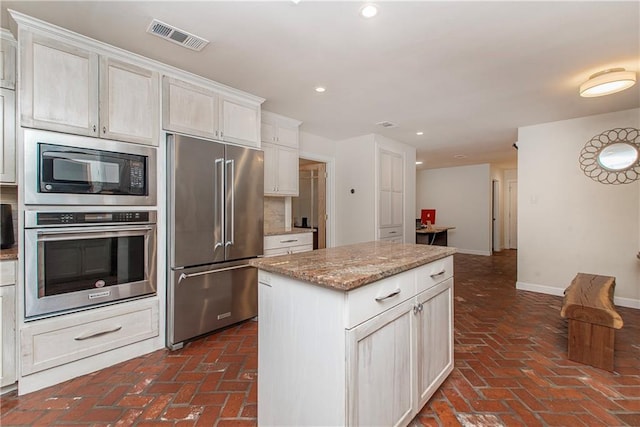 156 Oak Holw, Hammond, LA 70401 - kitchen with appliances with stainless steel finishes, brick floors, recessed lighting, baseboards, and light stone counters