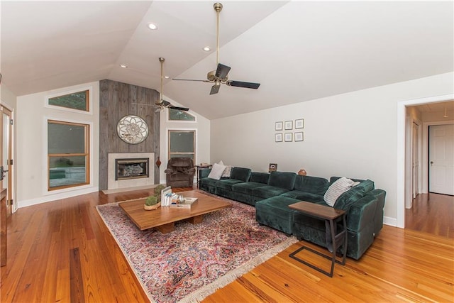 156 Oak Holw, Hammond, LA 70401 - living room featuring lofted ceiling, wood finished floors, a ceiling fan, baseboards, and a fireplace