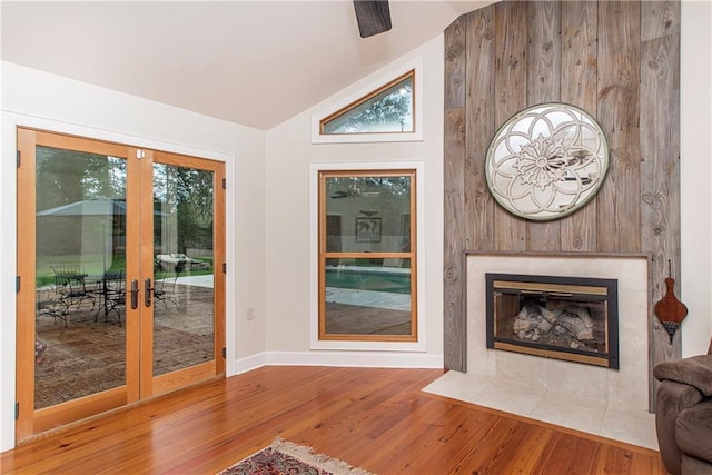 156 Oak Holw, Hammond, LA 70401 - unfurnished living room featuring lofted ceiling, wood finished floors, french doors, healthy amount of natural light, and baseboards