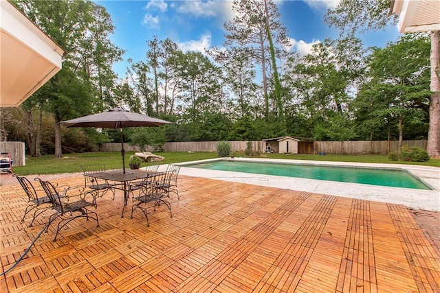 156 Oak Holw, Hammond, LA 70401 - view of pool featuring a storage unit, a patio, an outdoor structure, view of wooded area, and outdoor dining area