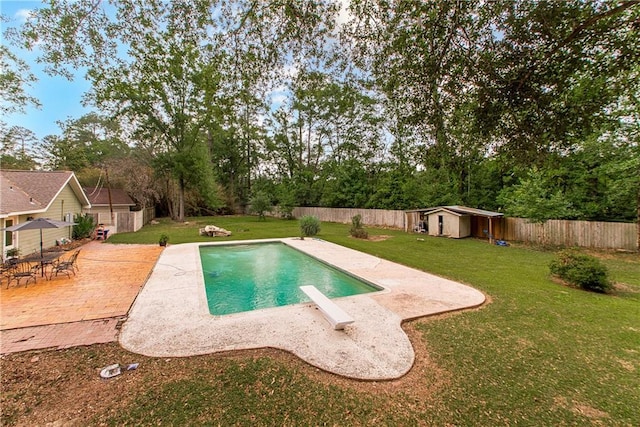 156 Oak Holw, Hammond, LA 70401 - view of swimming pool featuring a patio area, a shed, an outbuilding, and view of scattered trees