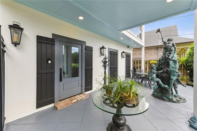 doorway to property with stucco siding and a patio