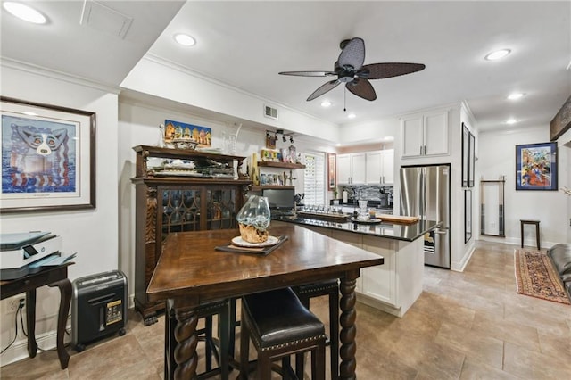 dining room featuring a ceiling fan, ornamental molding, and recessed lighting