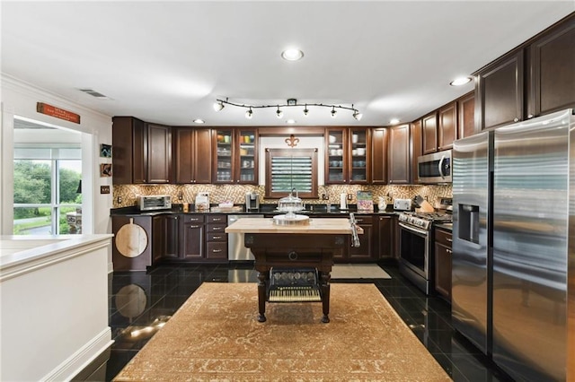 kitchen with appliances with stainless steel finishes, granite tiled floors, dark brown cabinets, recessed lighting, and ornamental molding