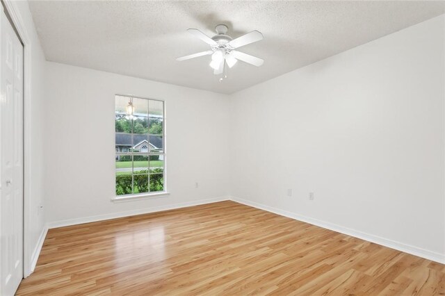 1155 Milan Dr, Mandeville, LA 70448 - empty room with a chandelier, a tray ceiling, crown molding, and light wood-type flooring