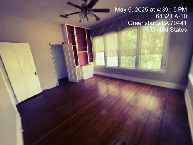 6396 10th Hwy, Greensburg, LA 70441 - unfurnished living room with wood finished floors, baseboards, and ceiling fan