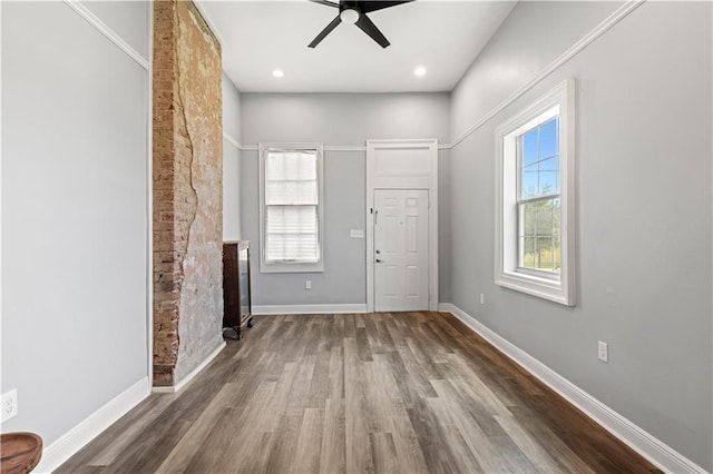 2025 Conti St, New Orleans, LA 70112 - foyer entrance with wood finished floors, a ceiling fan, baseboards, and a fireplace