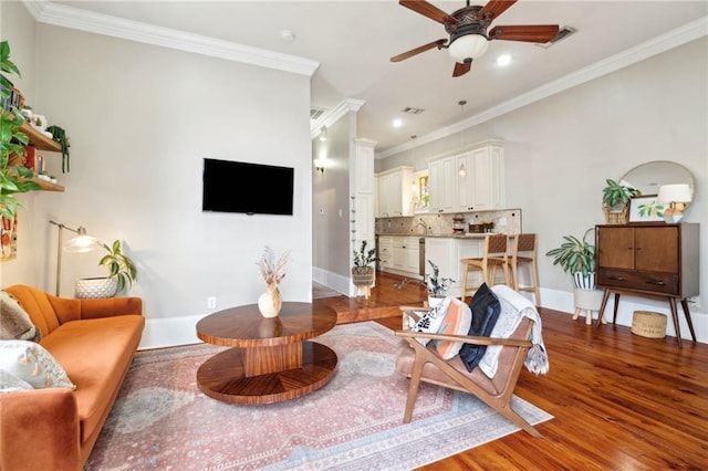 215 N Scott St, New Orleans, LA 70119 - living area with a ceiling fan, wood finished floors, crown molding, baseboards, and recessed lighting