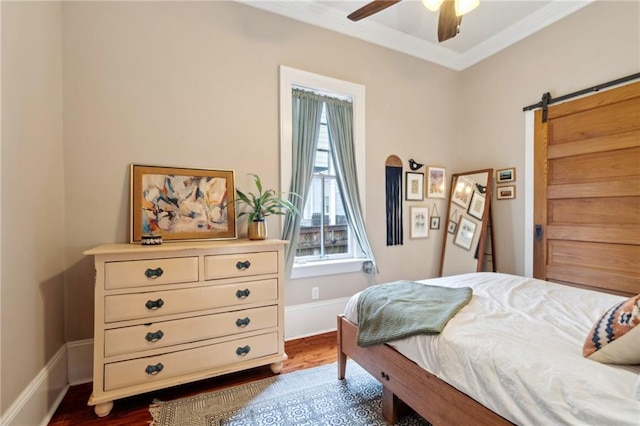 215 N Scott St, New Orleans, LA 70119 - bedroom featuring a barn door, ornamental molding, dark wood-style floors, baseboards, and ceiling fan