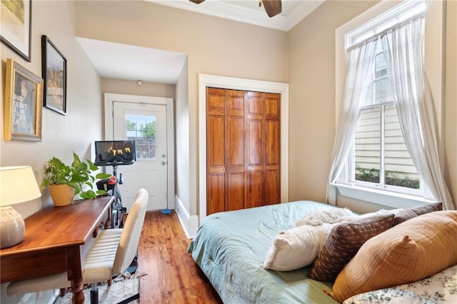 215 N Scott St, New Orleans, LA 70119 - bedroom featuring crown molding, light wood-style floors, a closet, and baseboards