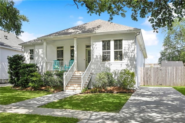 bungalow-style house featuring covered porch and roof with shingles