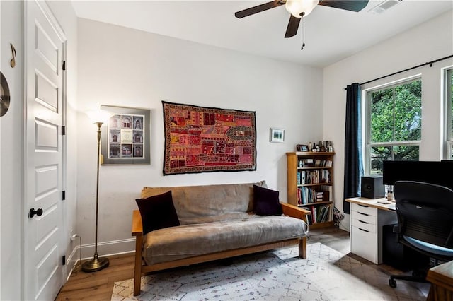 office with ceiling fan, light wood finished floors, and baseboards