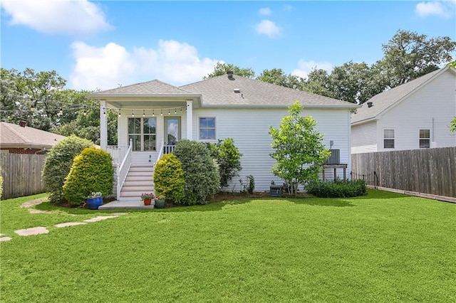 rear view of property with stairs and roof with shingles