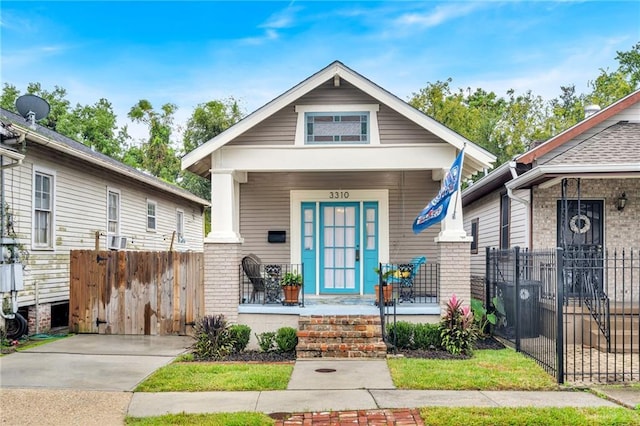 3310 Delachaise St, New Orleans, LA 70125 - shotgun-style home with a porch and fence