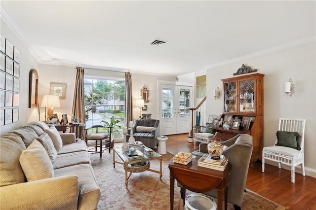 living area featuring ornamental molding and wood finished floors
