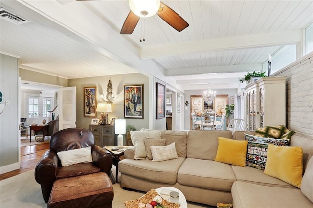 living room featuring a chandelier, beamed ceiling, ceiling fan, and wood finished floors