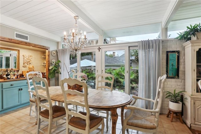 dining space featuring light tile patterned floors, beamed ceiling, and a chandelier