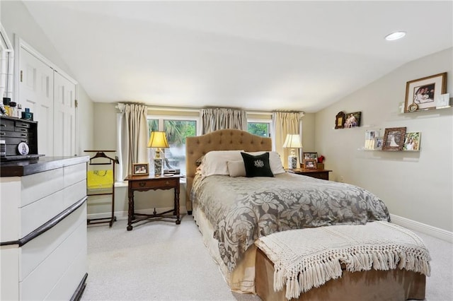 bedroom featuring baseboards, vaulted ceiling, light carpet, recessed lighting, and a closet