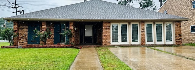 4408 Janice Ave, Metairie, LA 70003 - view of front of home with roof with shingles, brick siding, and a front yard