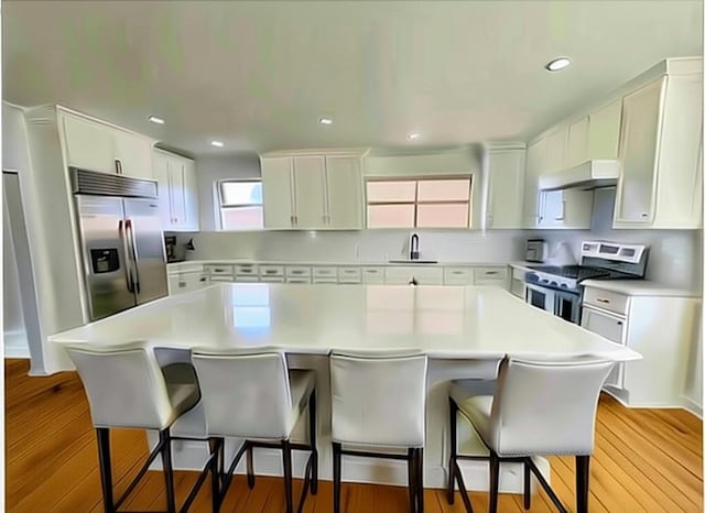 4408 Janice Ave, Metairie, LA 70003 - kitchen with appliances with stainless steel finishes, under cabinet range hood, white cabinets, light countertops, and a center island