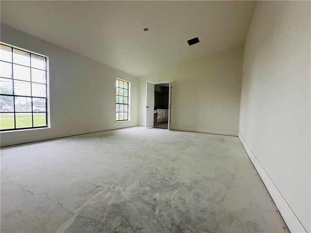 4408 Janice Ave, Metairie, LA 70003 - empty room with concrete floors, lofted ceiling, and baseboards