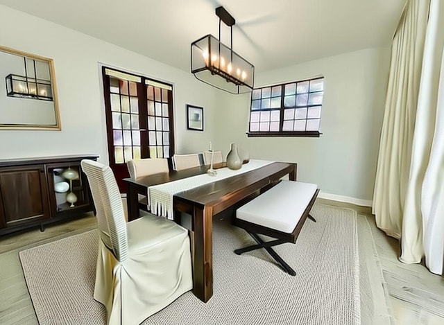 4408 Janice Ave, Metairie, LA 70003 - dining space with light wood-style flooring and a chandelier