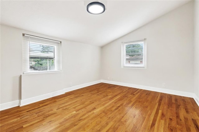 838 Jefferson St, Gretna, LA 70053 - empty room featuring lofted ceiling, plenty of natural light, light wood-type flooring, and baseboards