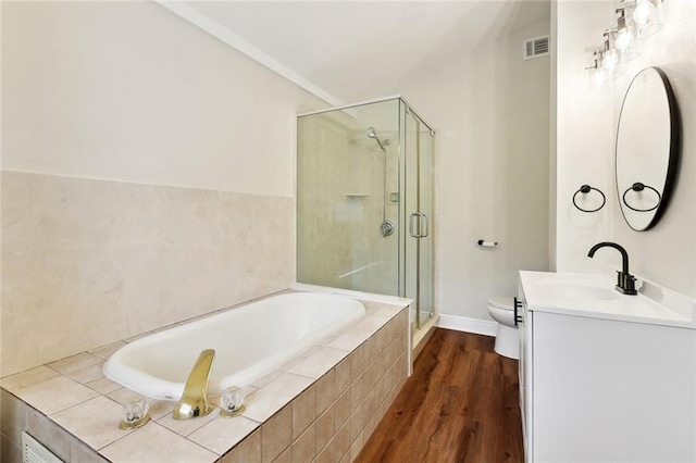838 Jefferson St, Gretna, LA 70053 - full bath featuring vanity, toilet, a stall shower, wood finished floors, and a garden tub
