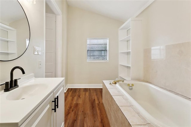 838 Jefferson St, Gretna, LA 70053 - full bathroom with wood finished floors, a garden tub, vanity, and baseboards