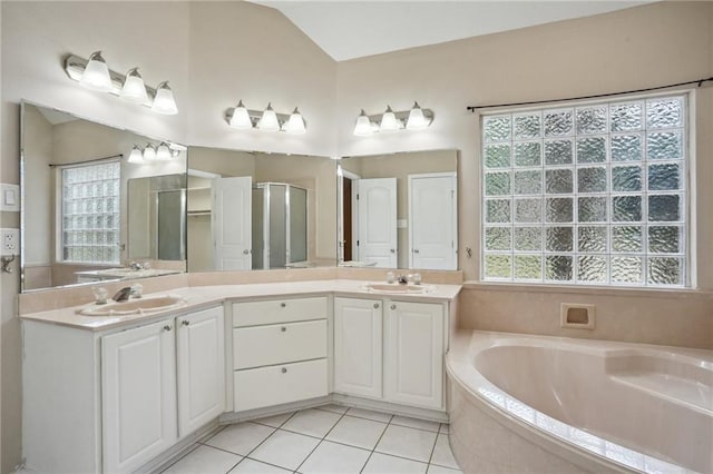 937 Crestwood Dr, Covington, LA 70433 - bathroom featuring a bath, double vanity, tile patterned flooring, vaulted ceiling, and a stall shower