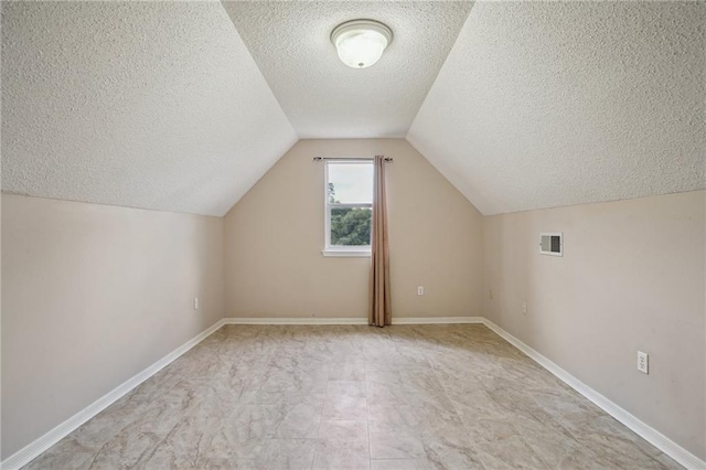 937 Crestwood Dr, Covington, LA 70433 - additional living space featuring a textured ceiling, vaulted ceiling, and baseboards