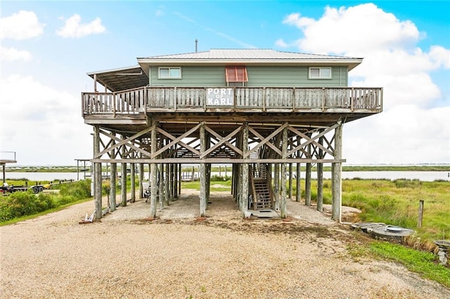 26360 Chef Menteur Hwy, New Orleans, LA 70129 - view of community featuring a deck with water view, a carport, and driveway