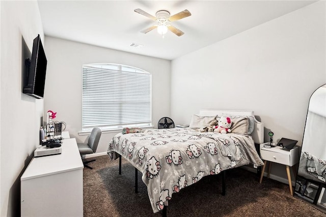 carpeted bedroom with ceiling fan and baseboards