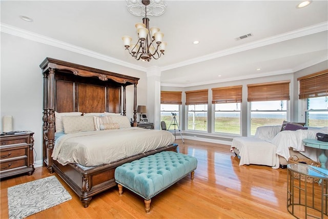 bedroom with a chandelier, multiple windows, light wood-style floors, ornamental molding, and recessed lighting